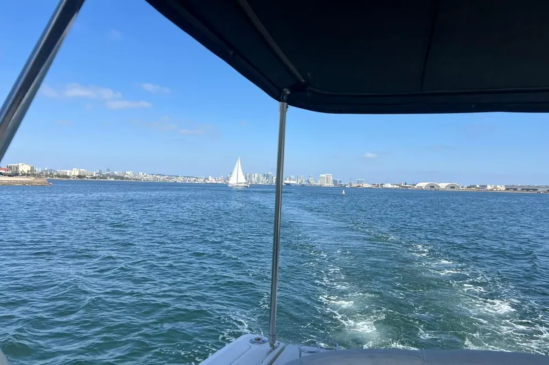 Slide: The Image of View from a 2005 Sea Ray 390 Sundancer, overlooking a city skyline and sailboat on the water. - 9