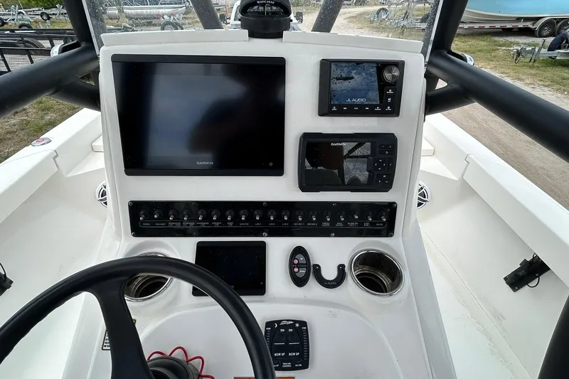 Slide: The Image of 2023 Pathfinder 2600 HPS boat dashboard with Garmin displays and JL Audio system. - 11