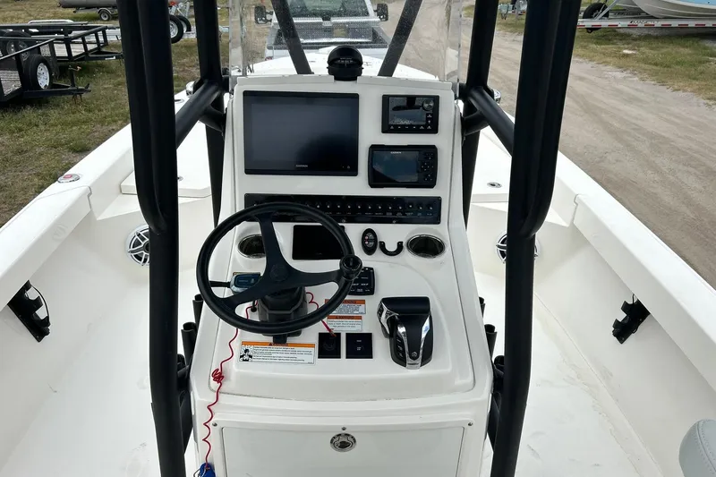 Slide: The Image of 2023 Pathfinder 2600 HPS boat console with steering wheel and electronic displays. - 12