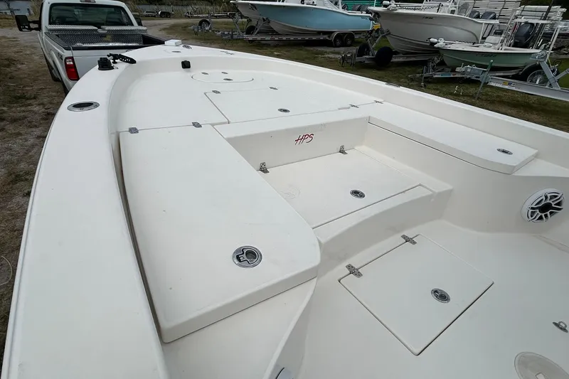 Slide: The Image of 2023 Pathfinder 2600 HPS boat deck, parked near a truck and other boats. - 13