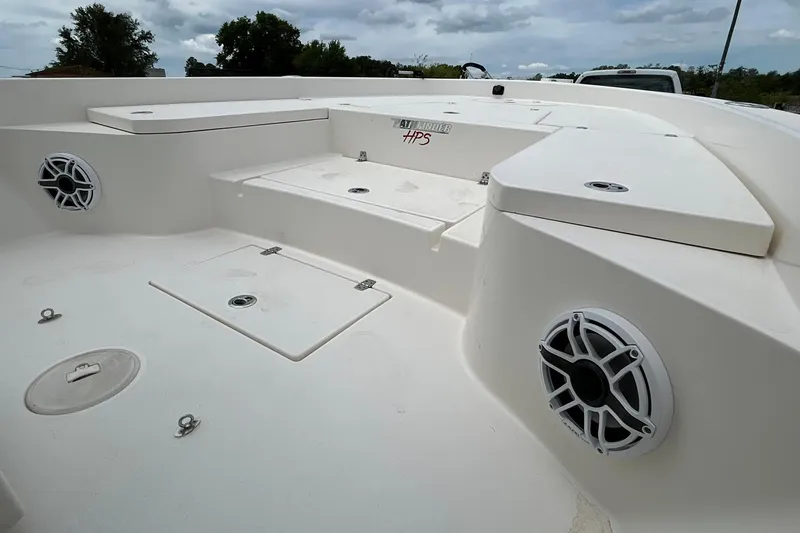 Slide: The Image of 2023 Pathfinder 2600 HPS boat deck with storage compartments and speakers. - 16