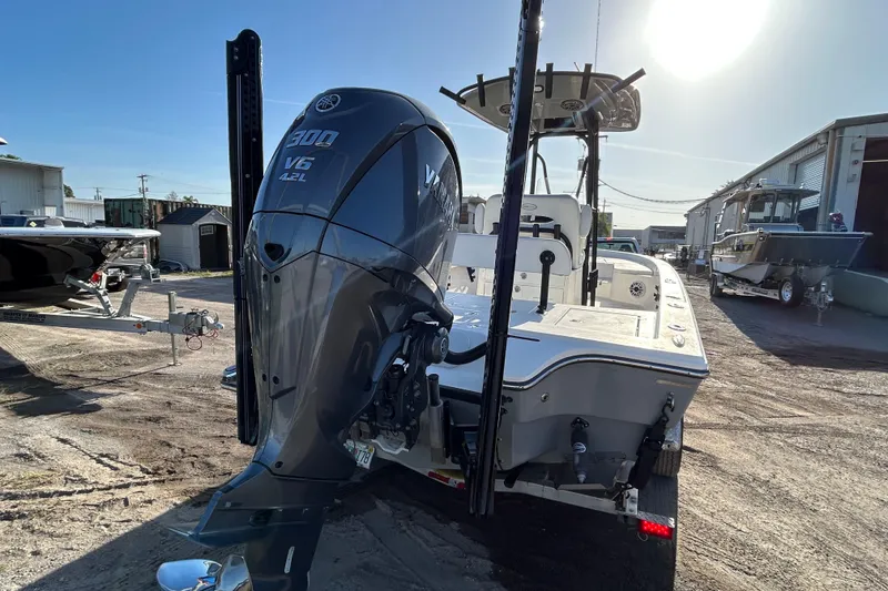 Slide: The Image of 2023 Pathfinder 2600 HPS boat with Yamaha V6 engine in a sunny outdoor setting. - 2
