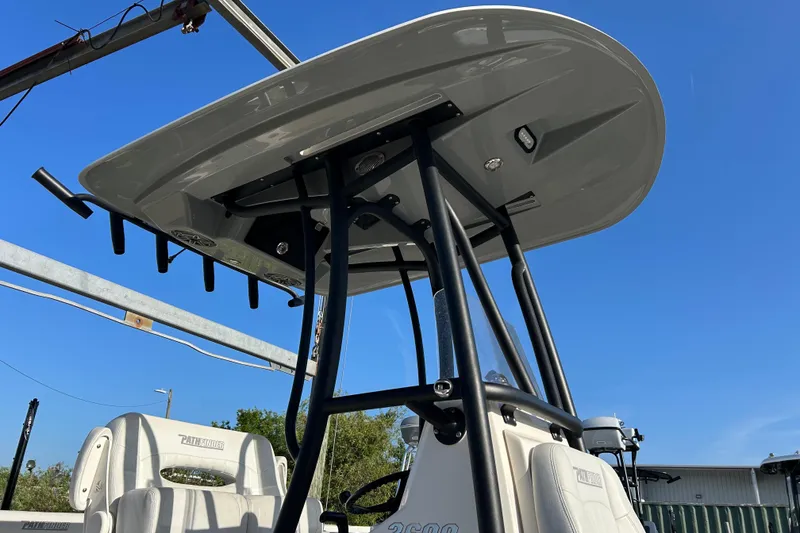 Slide: The Image of 2023 Pathfinder 2600 HPS boat with T-top and seating, under clear blue sky. - 5