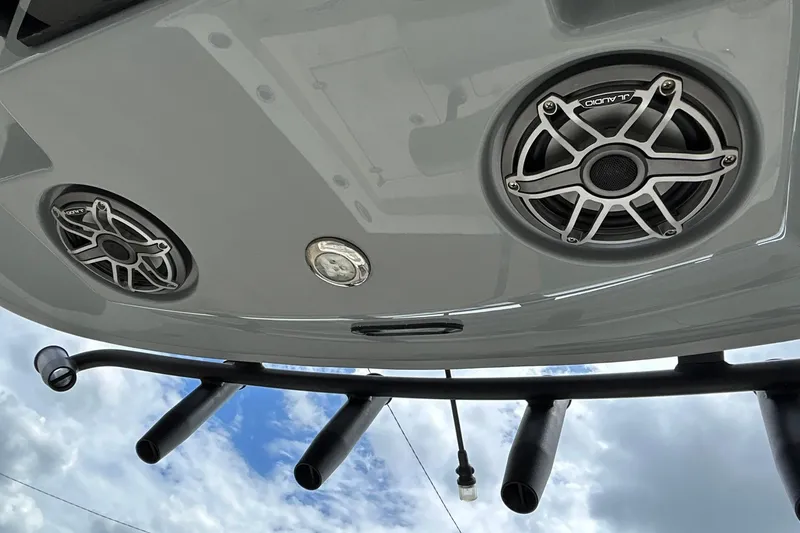 Slide: The Image of 2023 Pathfinder 2600 HPS boat speakers and rod holders against a cloudy sky. - 9