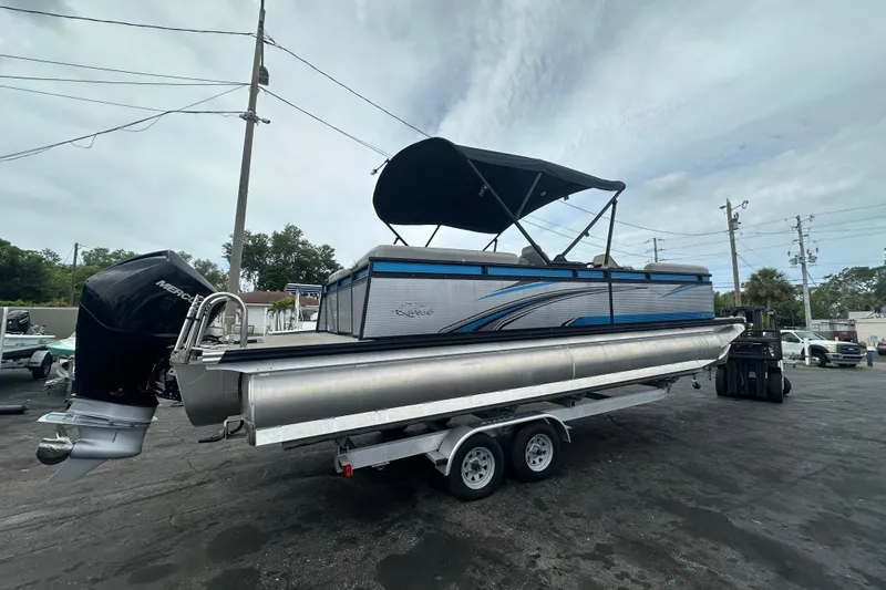 Slide: The Image of 2022 Qwest LTZ 824 pontoon boat on trailer with canopy and outboard motor. - 11