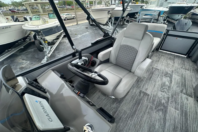 Slide: The Image of Interior of a 2022 Qwest LTZ 824 boat with modern steering and seating. - 16