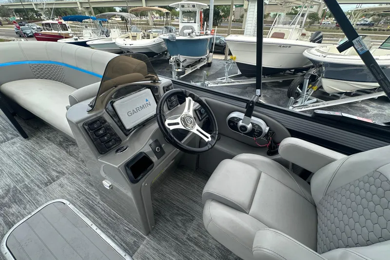 Slide: The Image of Interior of 2022 Qwest LTZ 824 boat with Garmin navigation system and plush seating. - 18