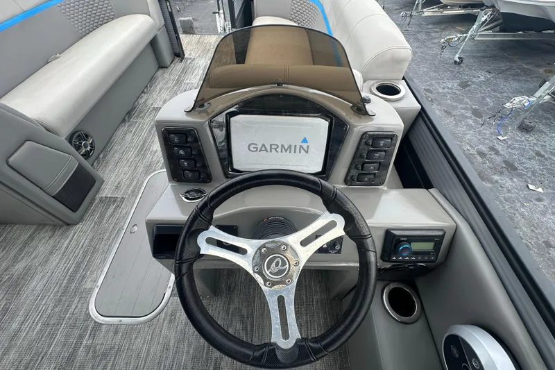 Slide: The Image of Interior of 2022 Qwest LTZ 824 boat with Garmin navigation system and steering wheel. - 19