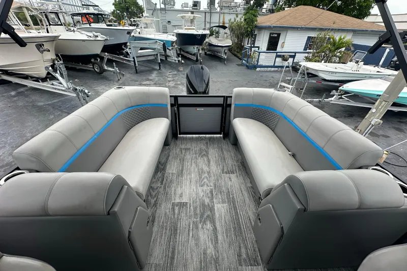 Slide: The Image of 2022 Qwest LTZ 824 pontoon boat interior with gray seating and blue accents. - 21
