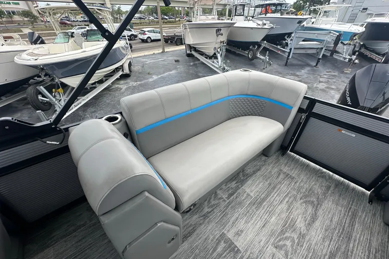 Slide: The Image of Interior of 2022 Qwest LTZ 824 boat with gray seating and blue accents. - 22