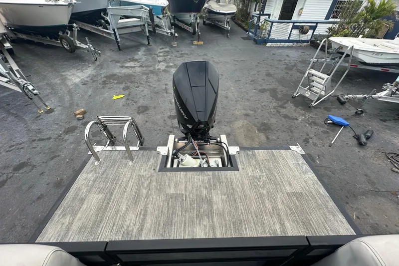Slide: The Image of Rear view of a 2022 Qwest LTZ 824 boat with outboard motor and ladder. - 24