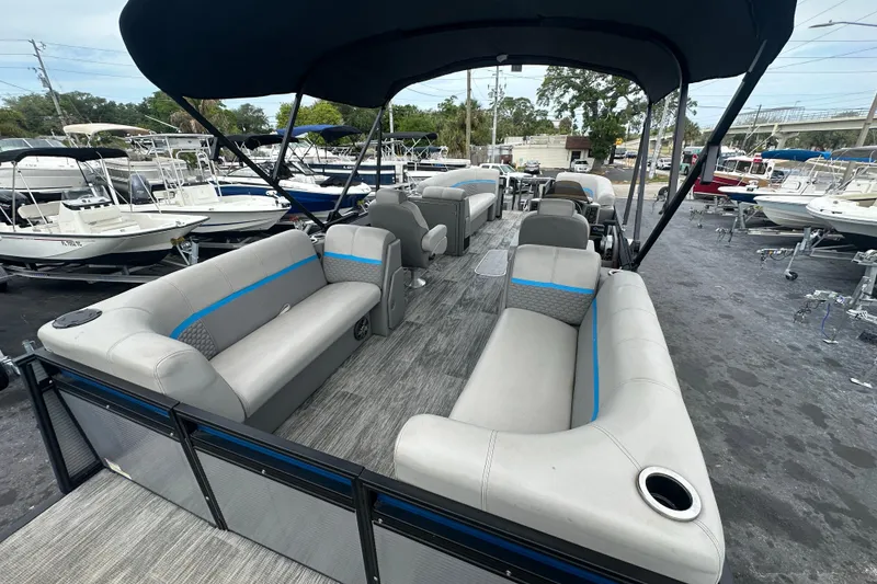 Slide: The Image of 2022 Qwest LTZ 824 pontoon boat with spacious seating and canopy in a marina. - 27