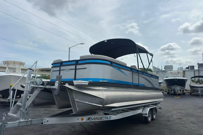 The Image of 2022 Qwest LTZ 824 pontoon boat on trailer, featuring sleek design and canopy. - 4
