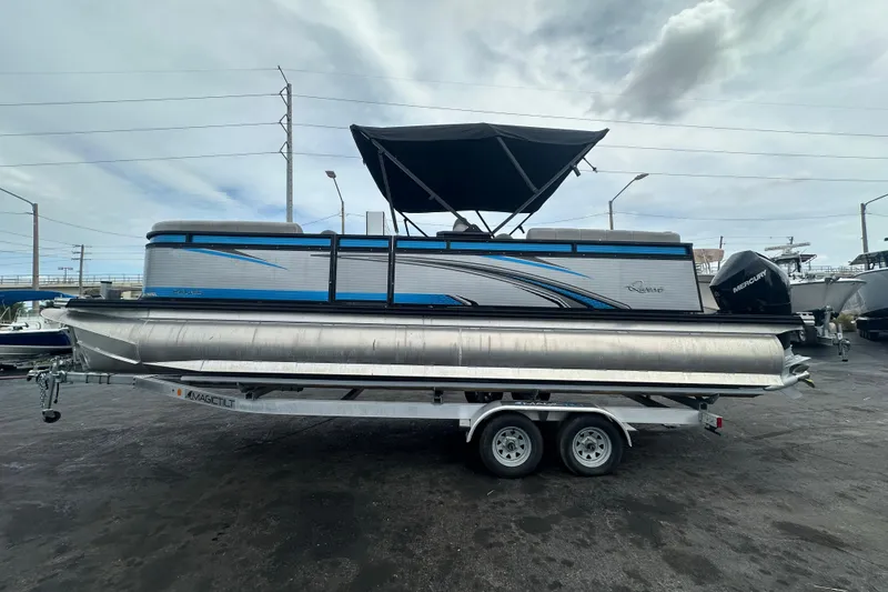 Slide: The Image of 2022 Qwest LTZ 824 pontoon boat on trailer, featuring sleek design and Mercury outboard motor. - 6