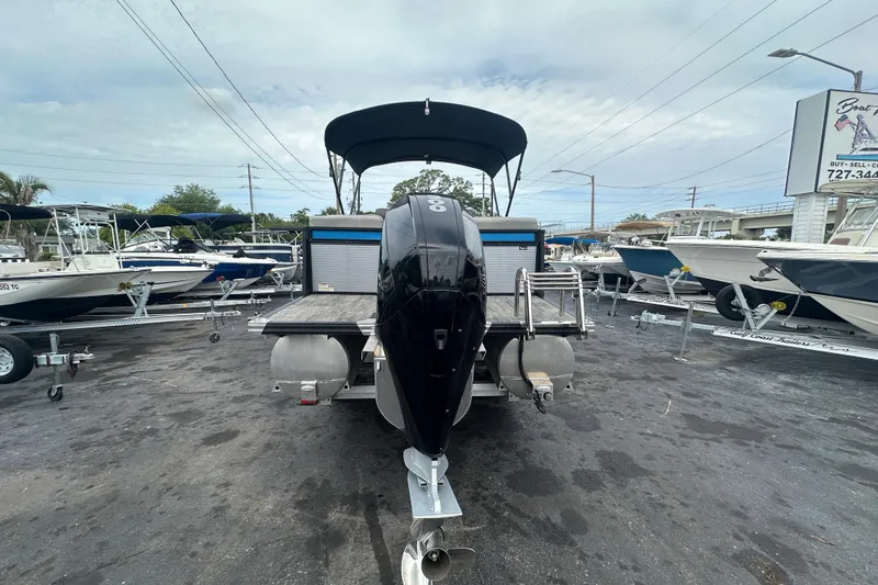 Slide: The Image of 2022 Qwest LTZ 824 pontoon boat with outboard motor in a boat dealership lot. - 9