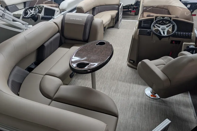 Slide: The Image of Interior of 2026 Sylvan Mirage 818 Cruise pontoon boat with plush seating and modern dashboard. - 11