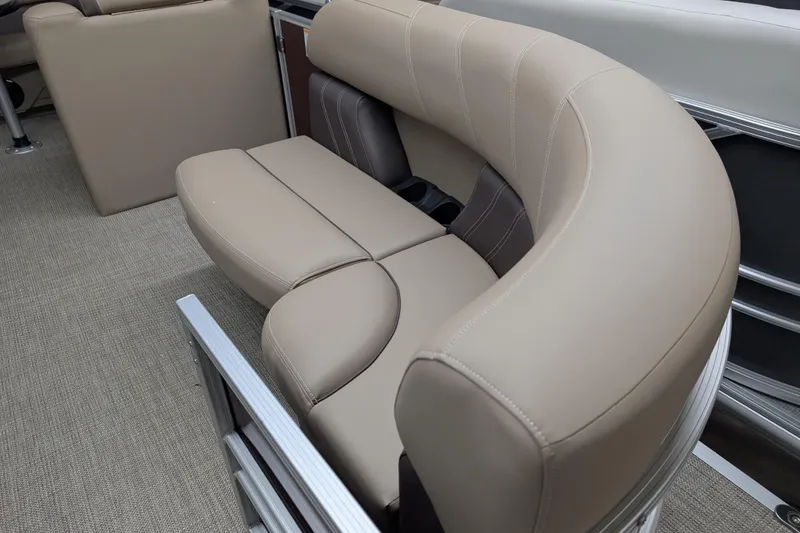Slide: The Image of 2026 Sylvan Mirage 818 Cruise interior with beige curved seating and carpeted flooring. - 4