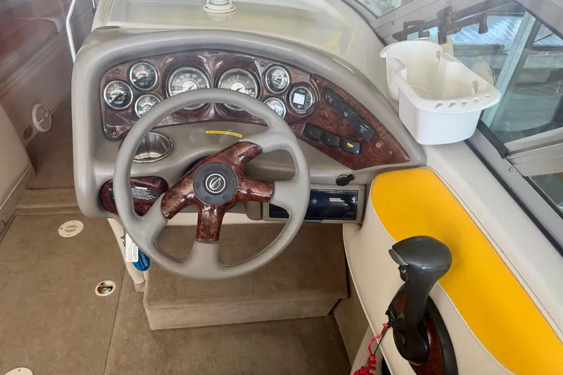 Slide: The Image of 2006 Crownline 266 BR boat dashboard with steering wheel and instrument panel. - 12