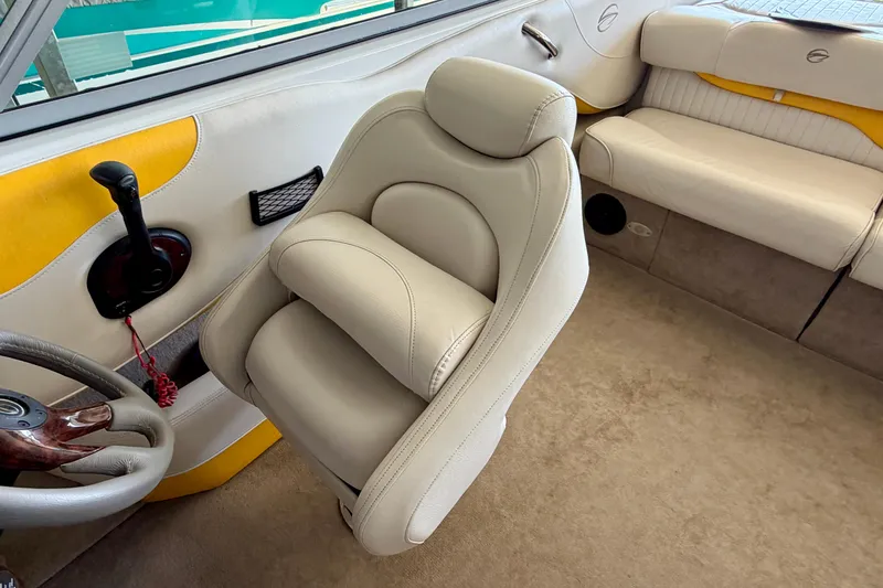 Slide: The Image of 2006 Crownline 266 BR boat interior with beige seating and steering wheel. - 13