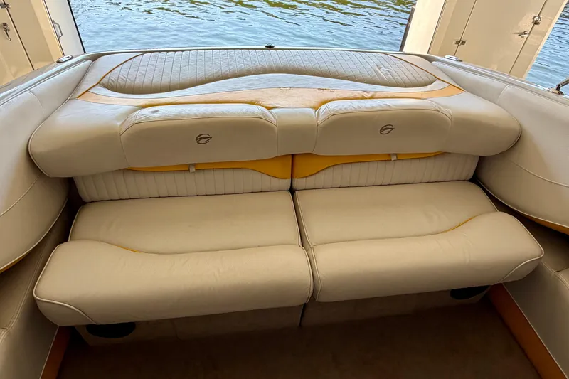 Slide: The Image of 2006 Crownline 266 BR boat interior with cushioned seating near water. - 15