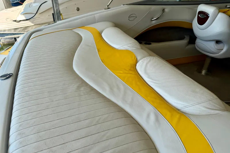 Slide: The Image of 2006 Crownline 266 BR boat interior with white and yellow seating. - 17