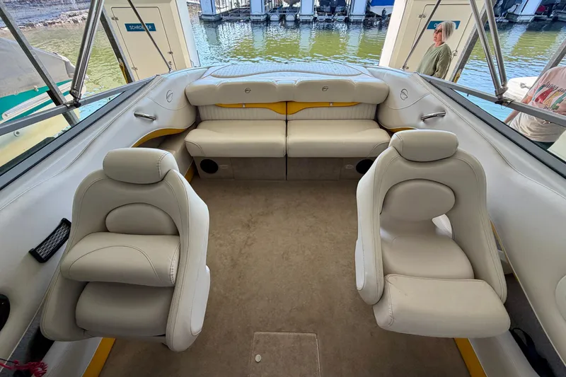 Slide: The Image of 2006 Crownline 266 BR boat interior with white seating and lake view. - 19