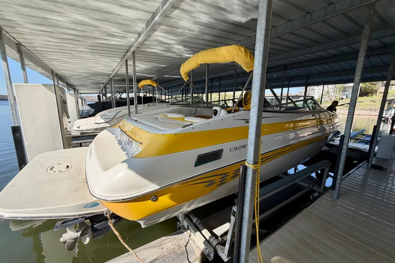 Slide: The Image of 2006 Crownline 266 BR boat docked under a covered marina. - 2