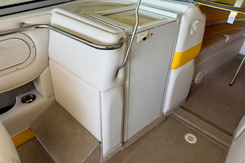 Slide: The Image of Interior of a 2006 Crownline 266 BR boat, featuring white and yellow seating. - 20