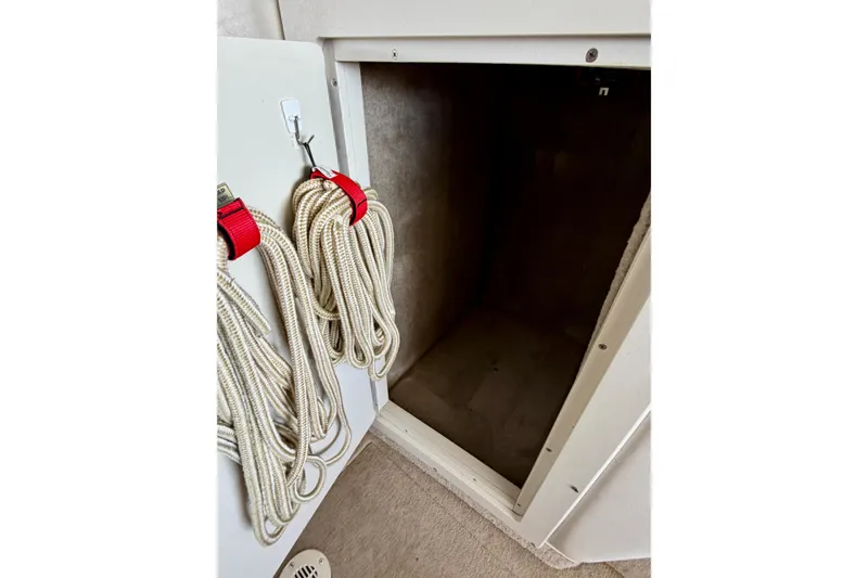 Slide: The Image of Storage compartment with ropes in a 2006 Crownline 266 BR boat. - 23