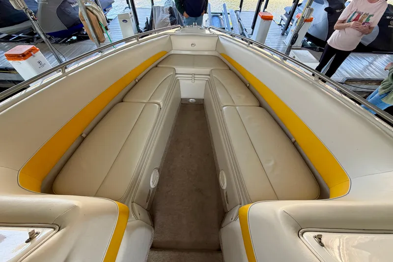 Slide: The Image of 2006 Crownline 266 BR boat interior with beige and yellow seating. - 25