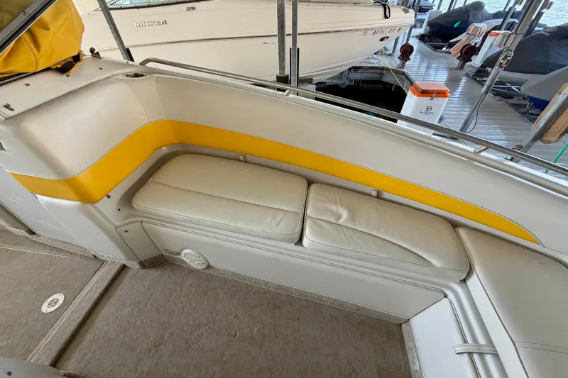 Slide: The Image of Interior seating of a 2006 Crownline 266 BR boat with yellow accents. - 28