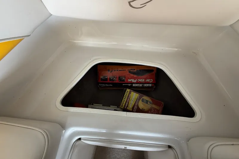 Slide: The Image of Storage compartment in a 2006 Crownline 266 BR boat with cleaning supplies. - 30
