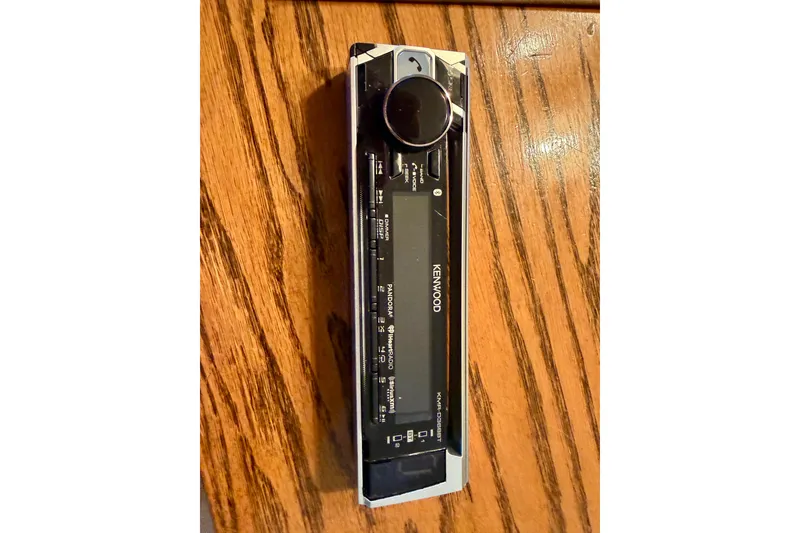 Slide: The Image of Kenwood stereo faceplate on wooden surface, compatible with 2006 Crownline 266 BR. - 33