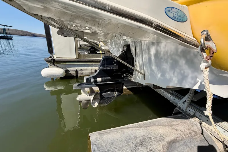 Slide: The Image of 2006 Crownline 266 BR boat docked, showing stern and propeller in water. - 7