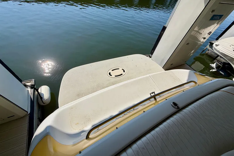 Slide: The Image of Rear view of 2006 Crownline 266 BR boat docked on calm water. - 8