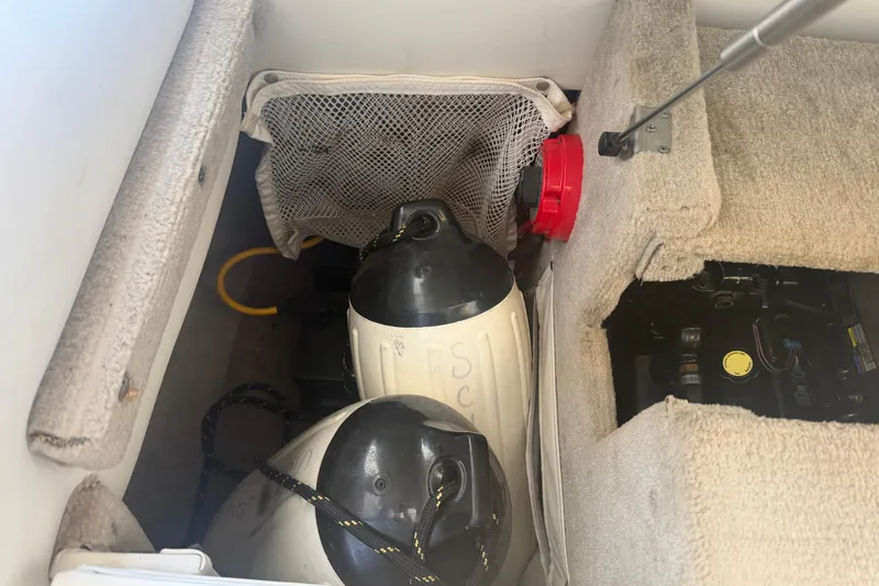 Slide: The Image of Storage compartment in a 2006 Crownline 266 BR boat with equipment and accessories. - 9