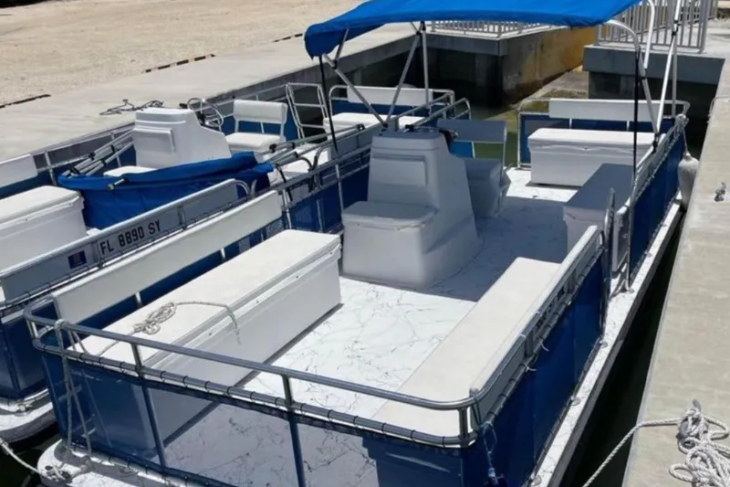 The Image of Pontoon boat by A&M Manufacturing, model 20, 2021, docked with blue canopy. - 1