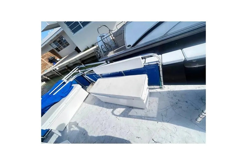 Slide: The Image of A&M Manufacturing 20 boat, 2021 model, with blue and white seating on deck. - 4