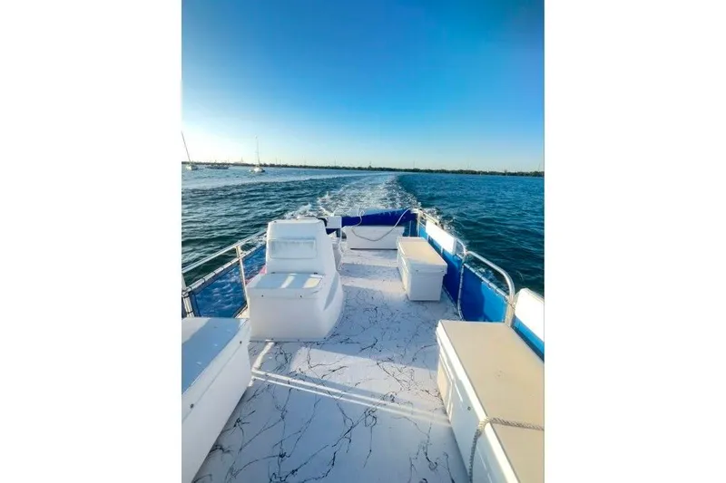 Slide: The Image of A&M Manufacturing 2021 model 20 boat cruising on open water under clear blue skies. - 5
