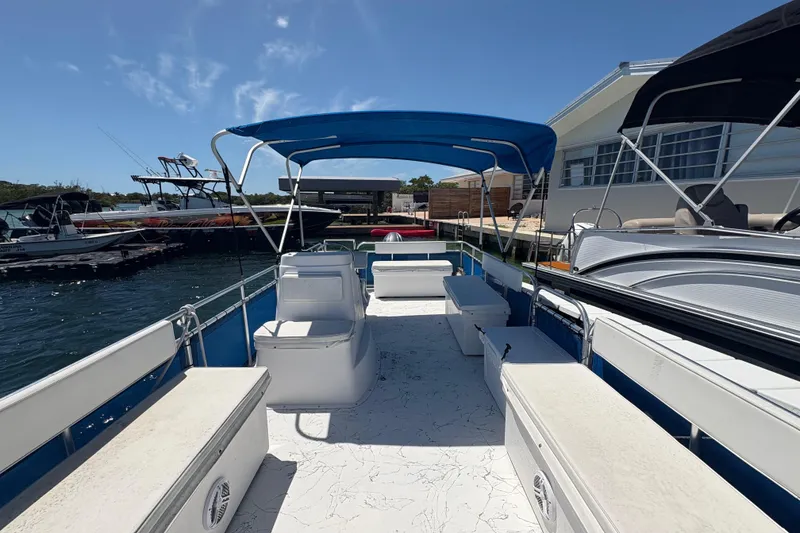 Slide: The Image of 2021 A&M Manufacturing Salty boat with blue canopy docked at marina. - 11