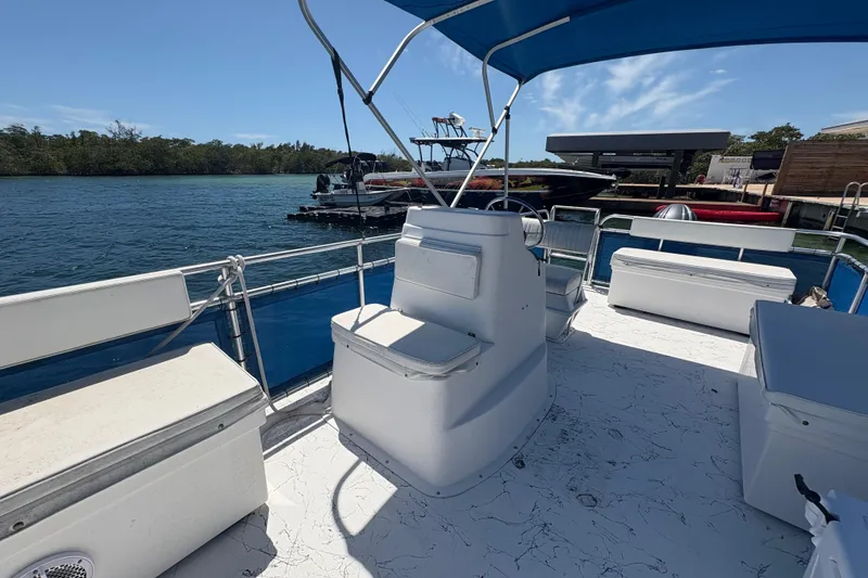 Slide: The Image of 2021 A&M Manufacturing Salty boat with blue canopy on calm water. - 15