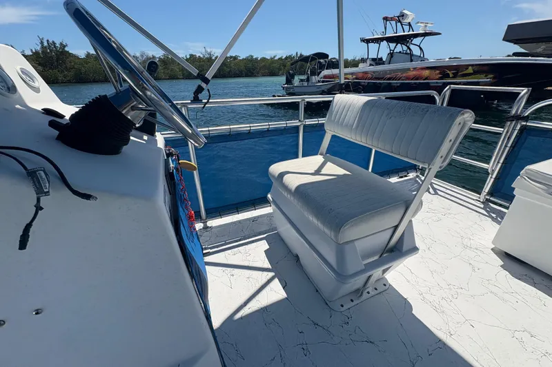 Slide: The Image of Interior of 2021 A&M Manufacturing Salty boat with white seating and steering wheel. - 18