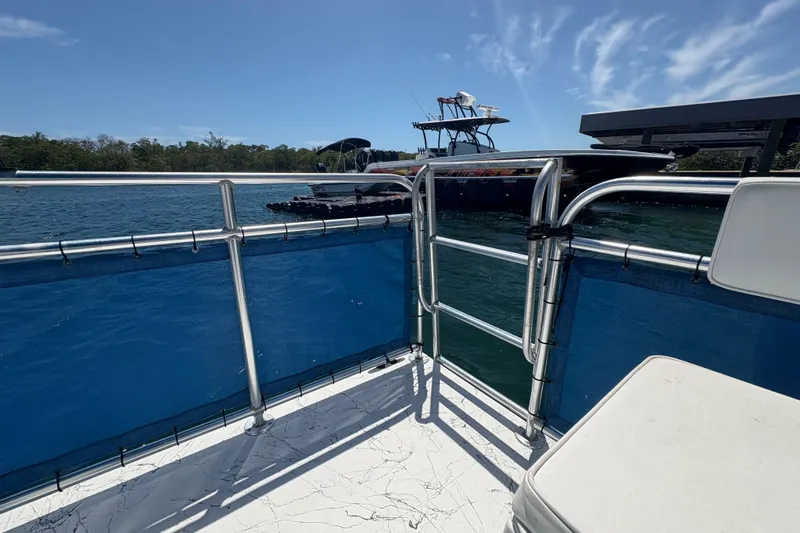 Slide: The Image of Deck view from 2021 A&M Manufacturing Salty boat, overlooking water and docked vessels. - 22