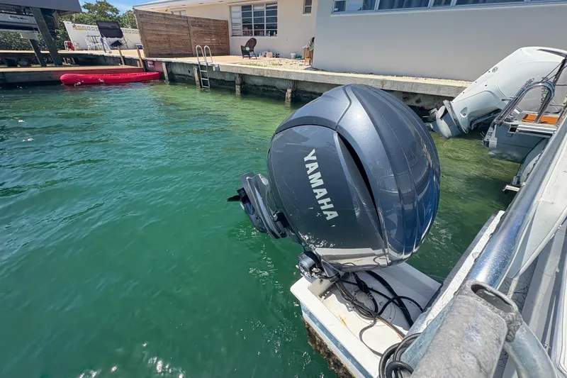 Slide: The Image of Outboard motor by Yamaha on a docked boat, clear water, A&M Manufacturing Salty 2021. - 25