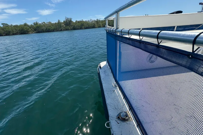 Slide: The Image of Boat railing on A&M Manufacturing's 2021 Salty model, cruising on a sunny lake. - 26