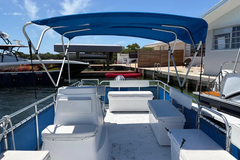 Slide: The Image of 2021 A&M Manufacturing Salty boat with blue canopy docked at marina. - 27