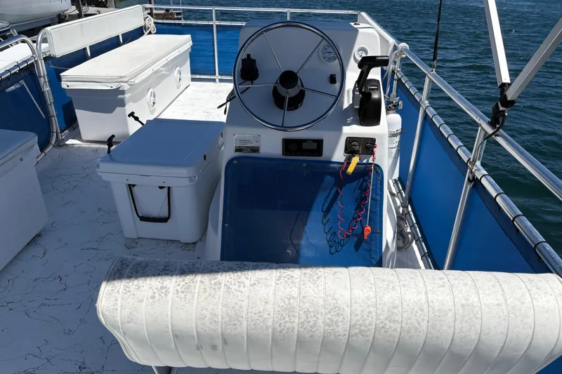 Slide: The Image of 2021 A&M Manufacturing Salty boat helm with steering wheel and controls on open water. - 32