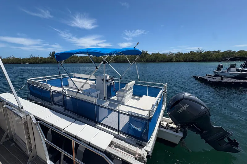 The Image of A&M Manufacturing Salty 20 pontoon boat, 2021, on calm water with blue canopy. - 9
