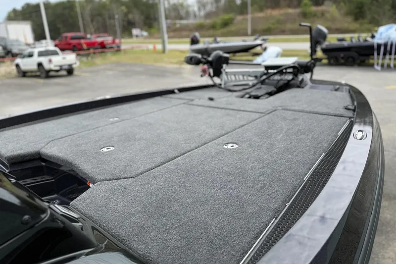 Slide: The Image of 2026 iKon vls20 boat deck with gray carpet, parked outdoors. - 7