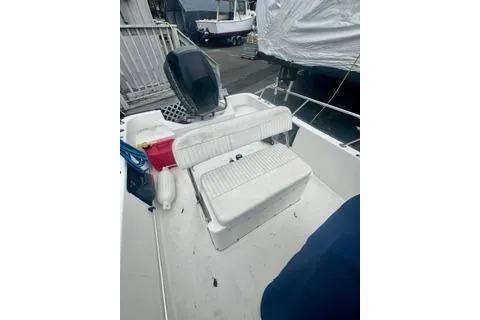 Slide: The Image of 2014 Boston Whaler Montalk boat interior with seating and storage. - 15